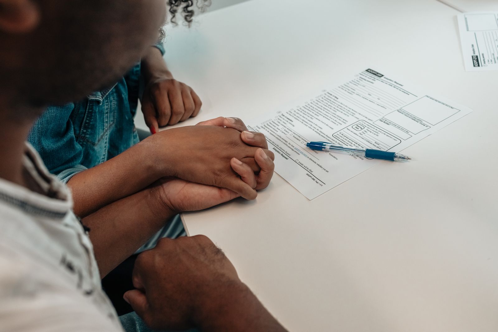 A family reviewing paperwork together at a kitchen table